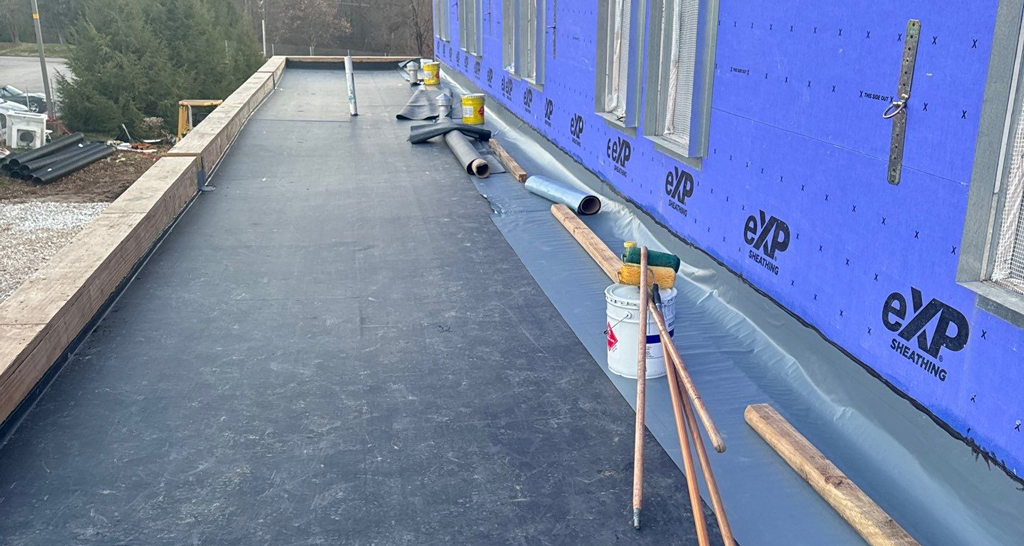 Black EPDM membrane roofing system on a low-slope roof