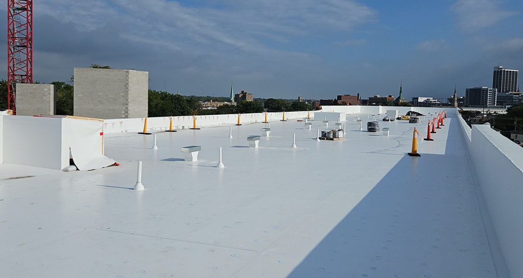 White TPO membrane roofing system on a commercial building